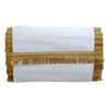 White napkin with gold fringe on a white background