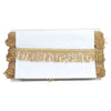 White card with gold fringes on a white background