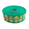Roll of green lace with gold embroidery on a white background