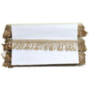 Gold fringe table runner on a white background