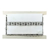White fabric roll with black lace trim on a white background