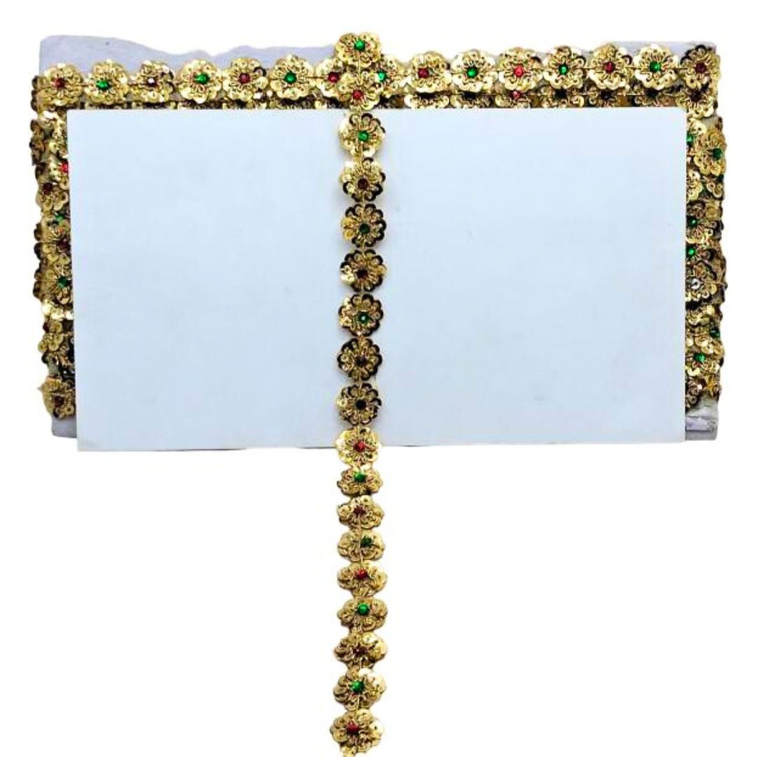 Decorative white clutch with gold floral embellishments on a white background