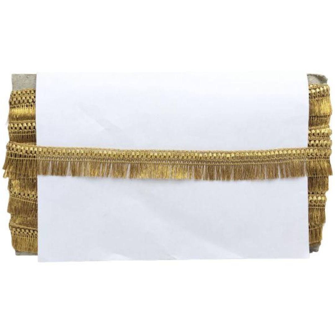 White pillow with gold fringe on a white background