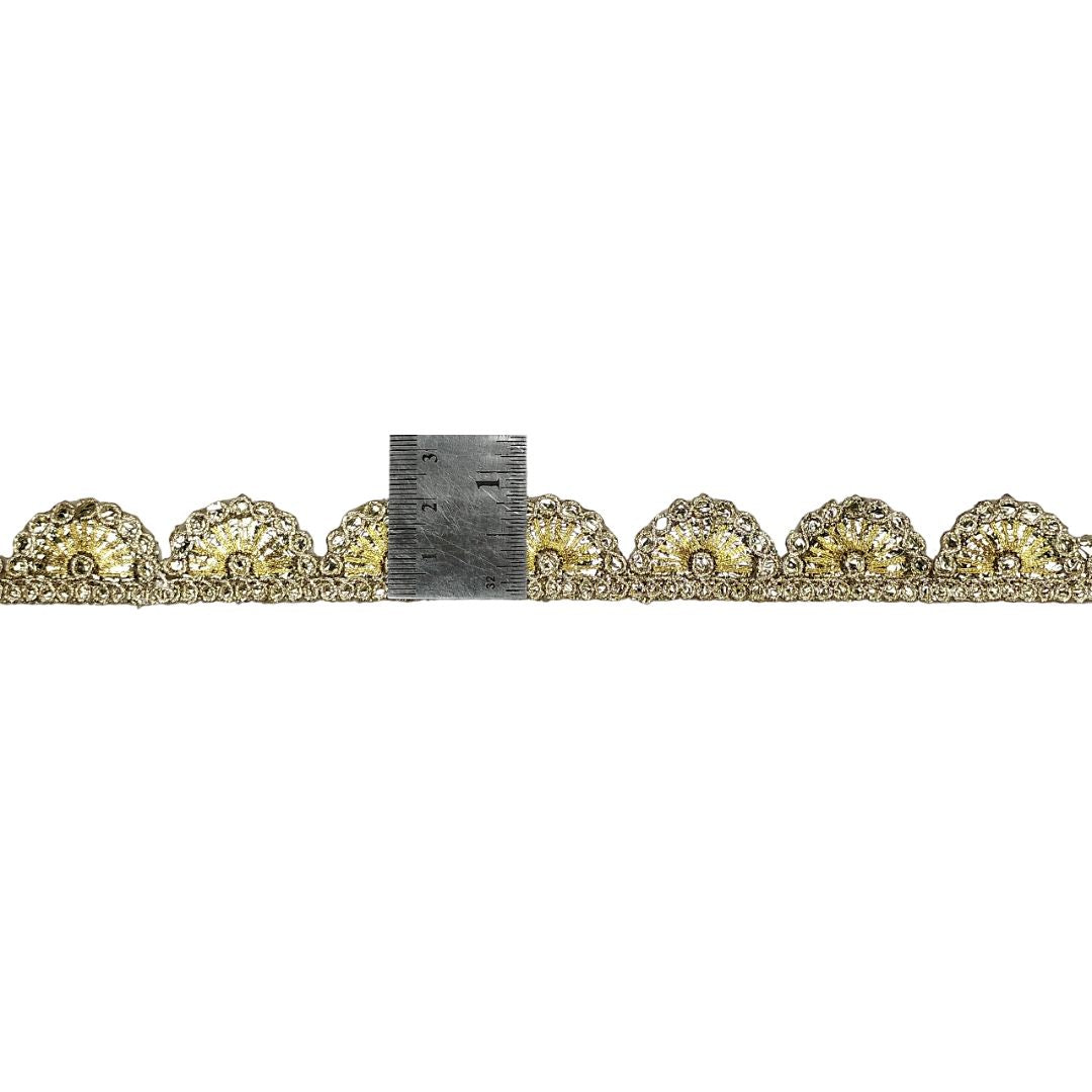 Row of yellow gemstones with a ruler for scale on a white background