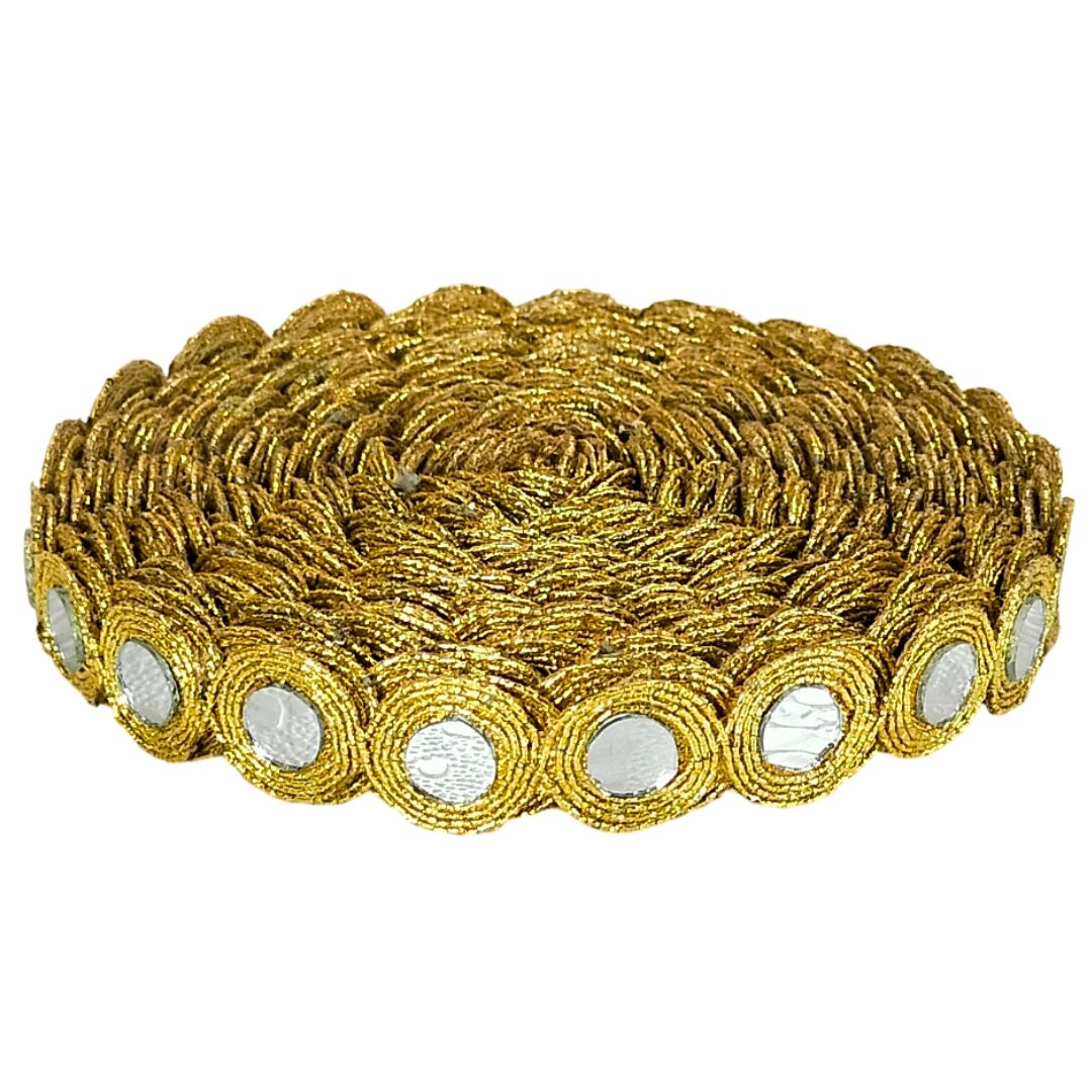 Gold bracelet with circular patterns and embedded stones on a white background