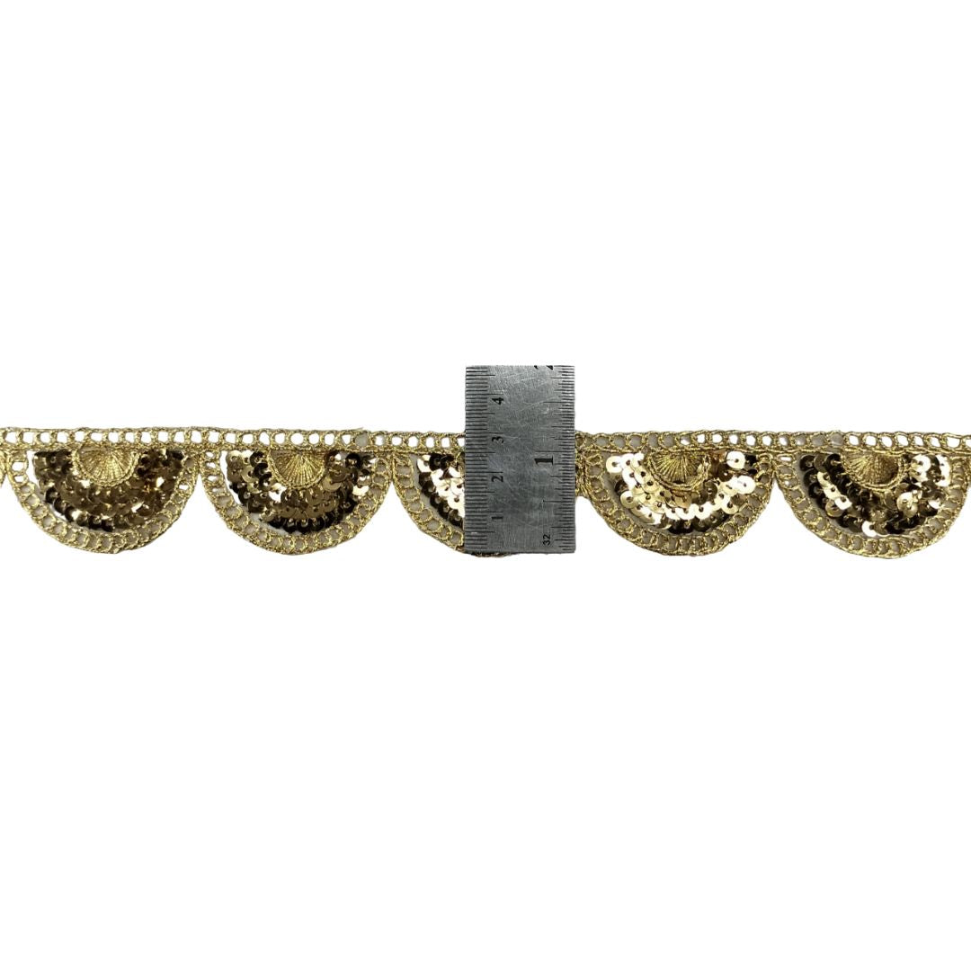 Decorative gold fabric trim with scalloped edges on a white background