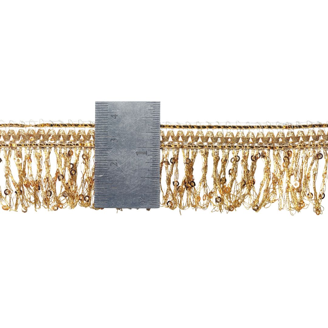Gold fringe trim with a measuring gauge on a white background