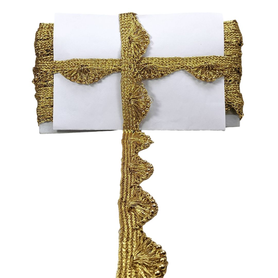 Gold decorative ribbon with scalloped edge on a white background