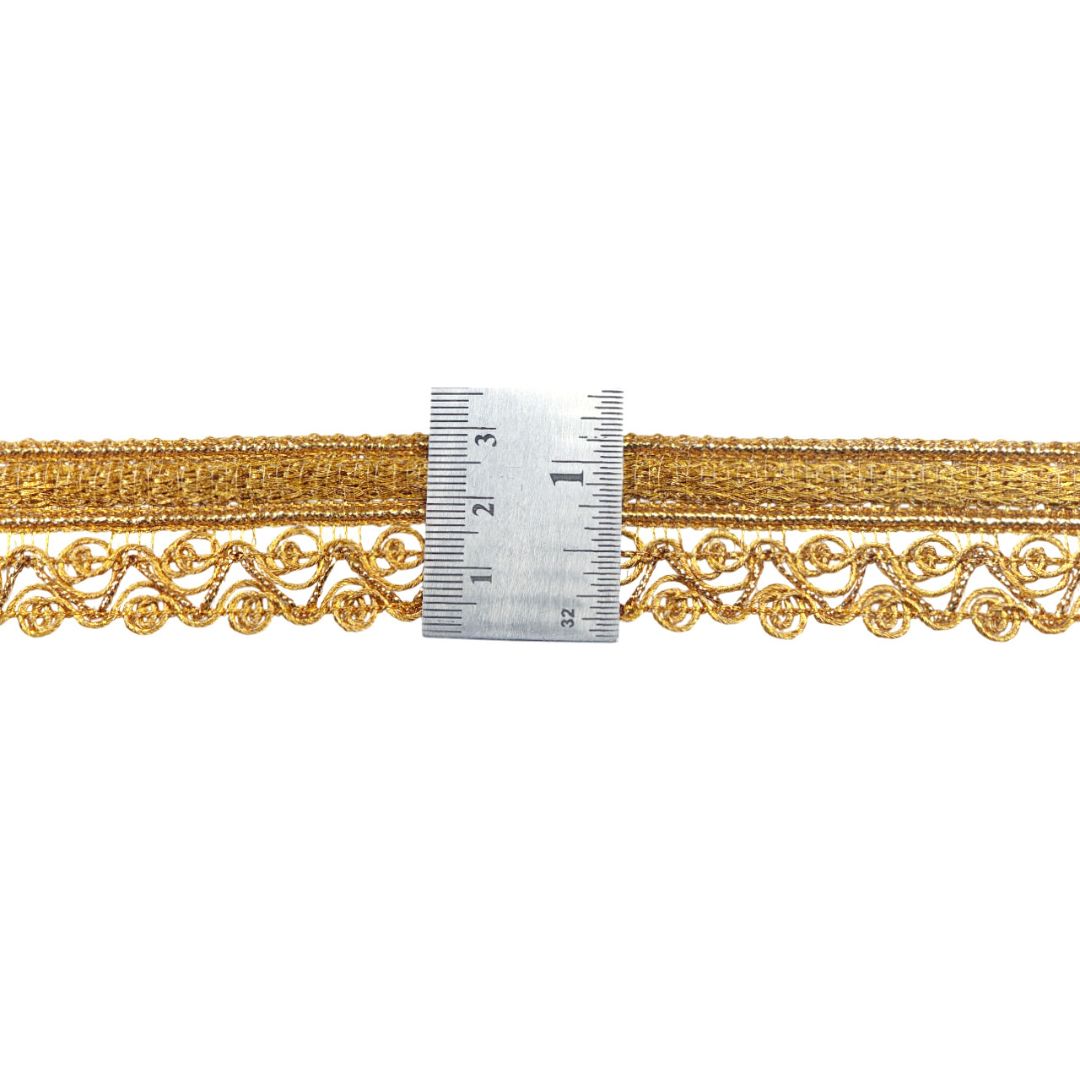 Gold lace trim with a ruler for measurement on a white background