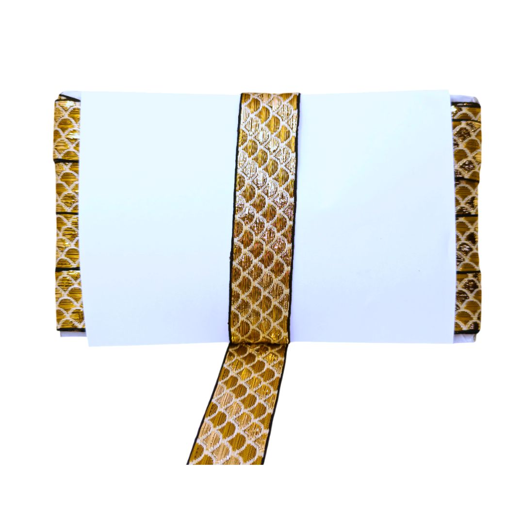 White notebook with gold and brown patterned arm rests on a white background