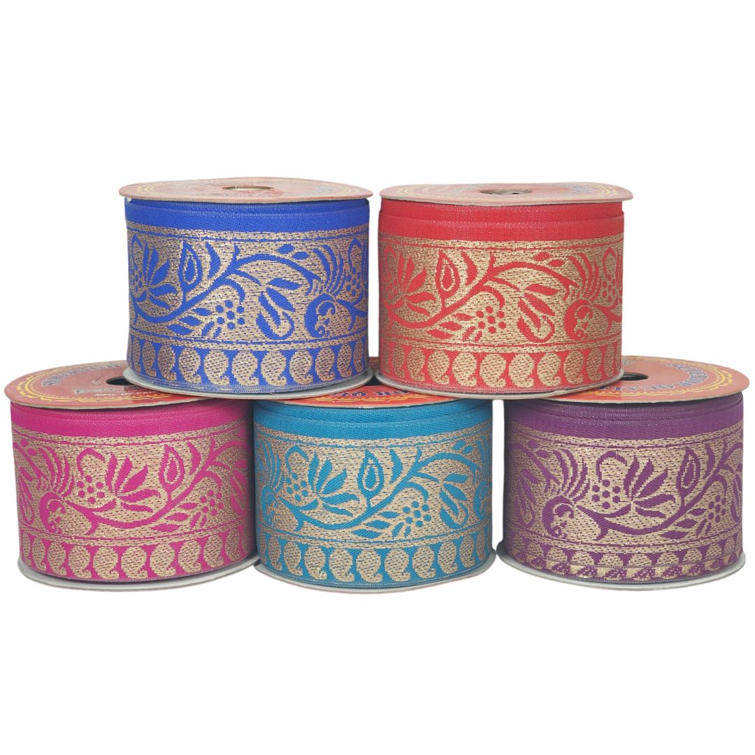 Five spools of decorative ribbon in blue, red, pink, and purple with floral patterns on a white background.
