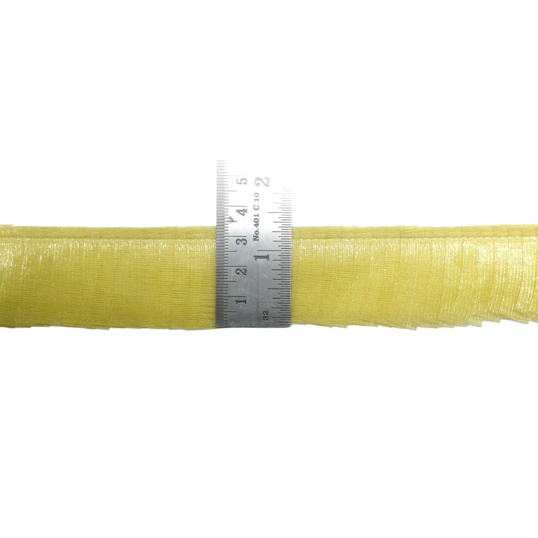 Roll of yellow fiberglass mat with a ruler for scale on a white background