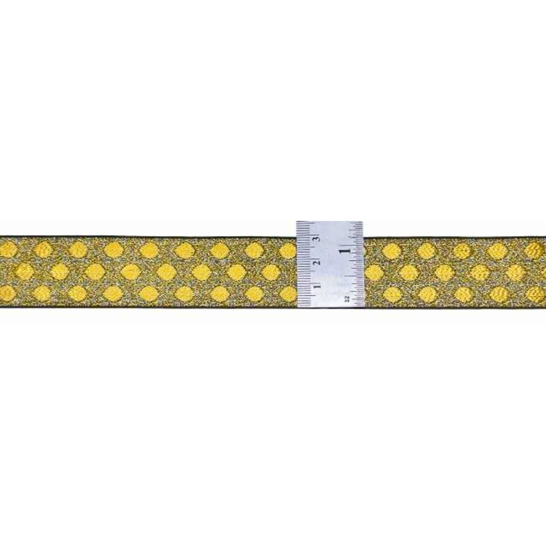 Gold ribbon with yellow polka dots and a ruler for scale on a white background