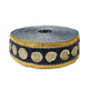 Roll of decorative ribbon with gold and blue pattern on a white background