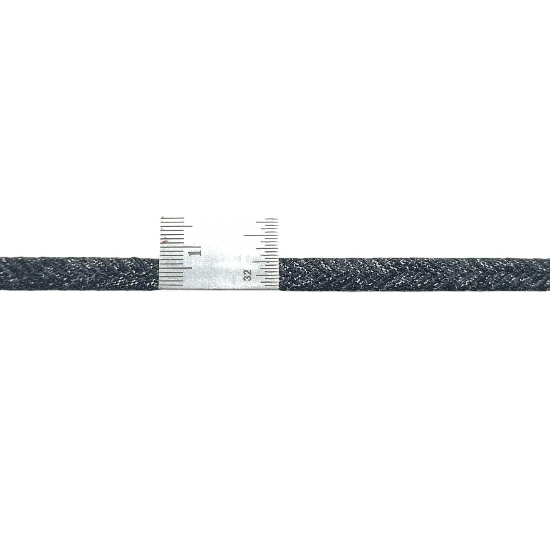 Black and white braided cable with measurement scale on a white background
