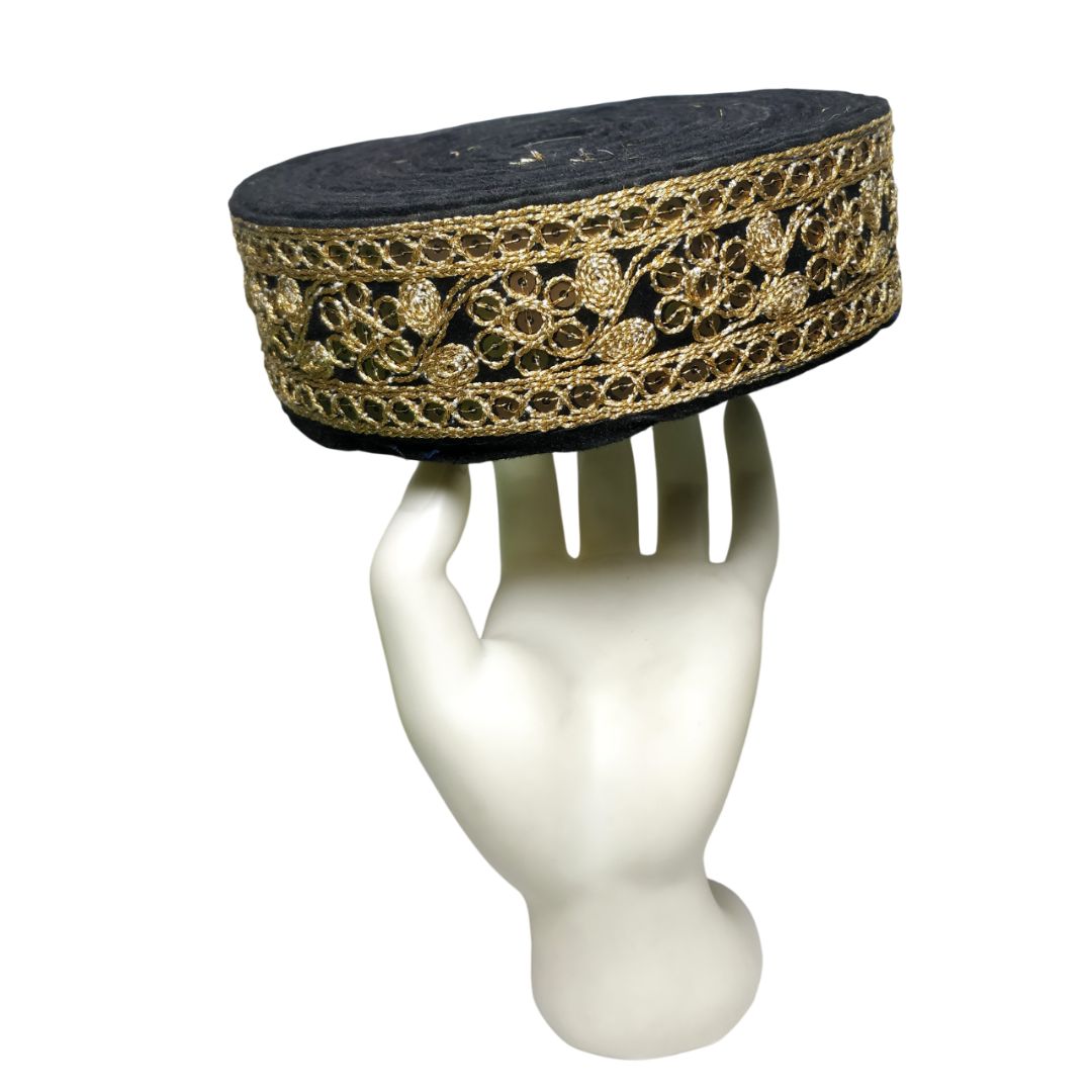 Decorative headband with gold lace on a mannequin head against a white background