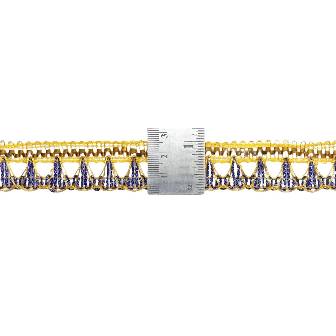 Gold and blue decorative trim with a ruler for scale on a white background