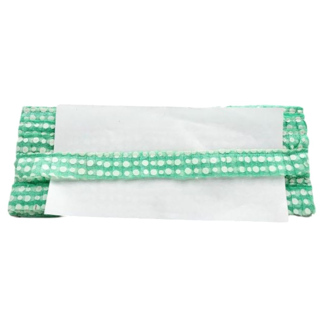 Green and white polka dot headband on a white background