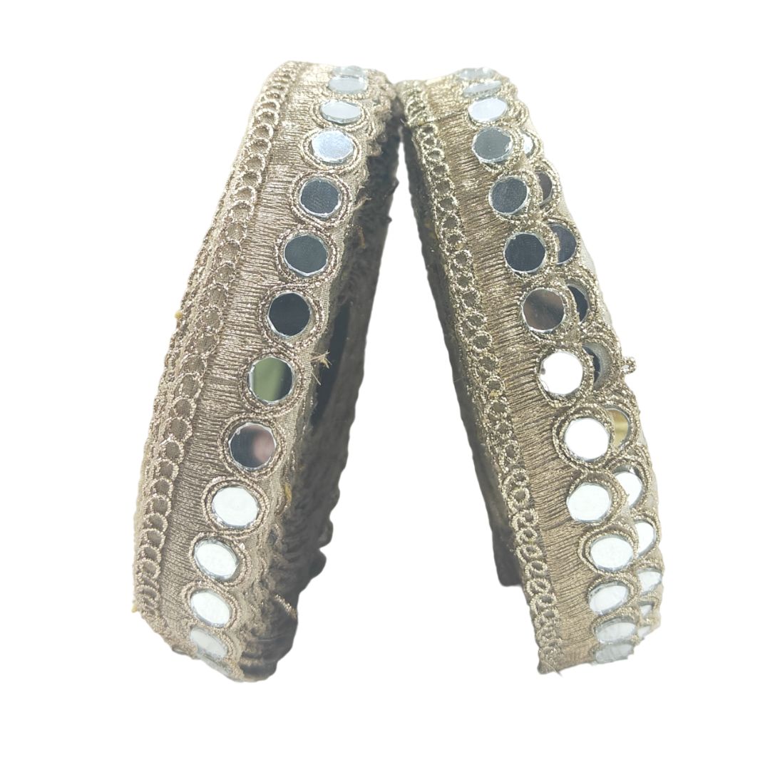 Decorative ribbon with metallic accents on a white background