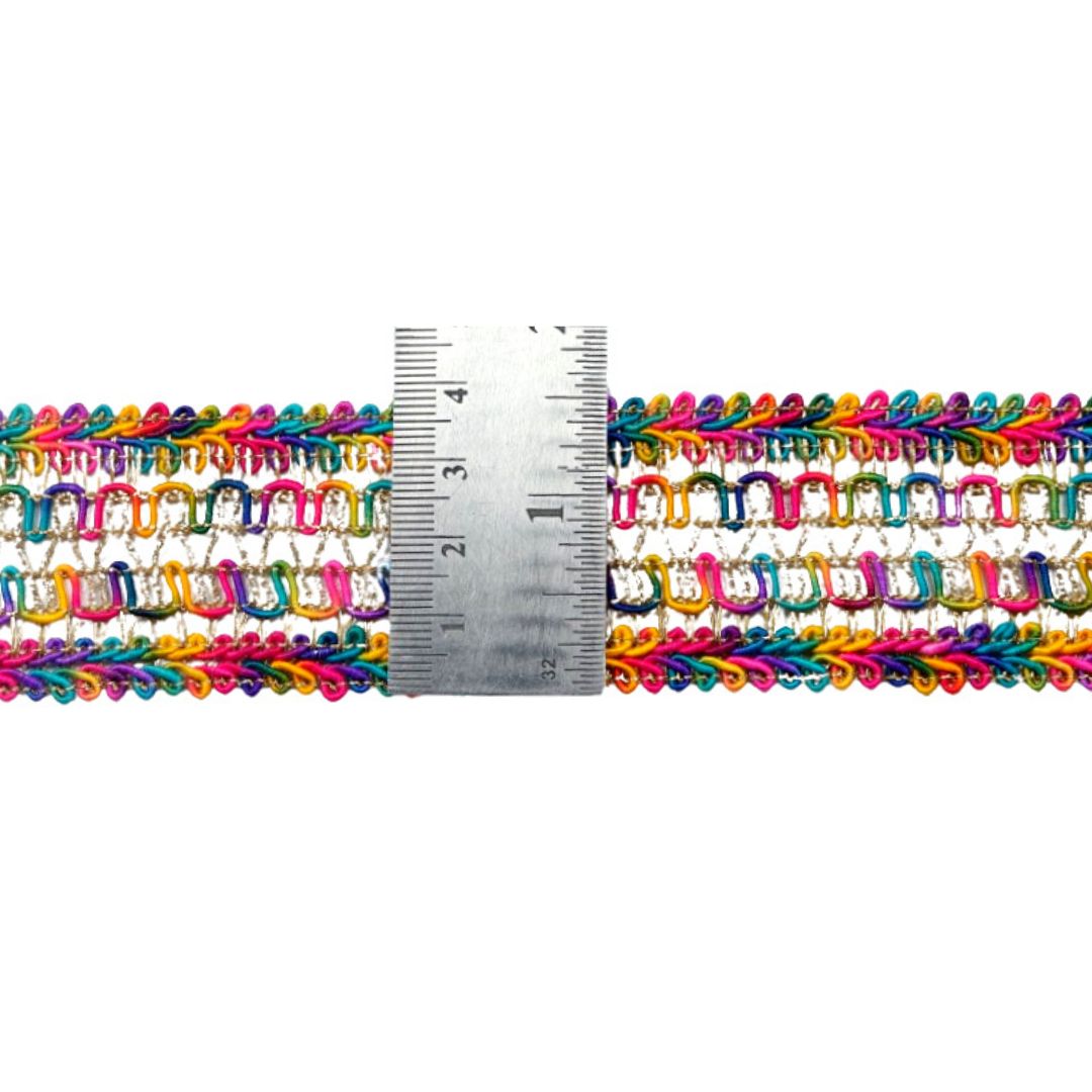 Multicolored crochet chain with a ruler for scale on a white background