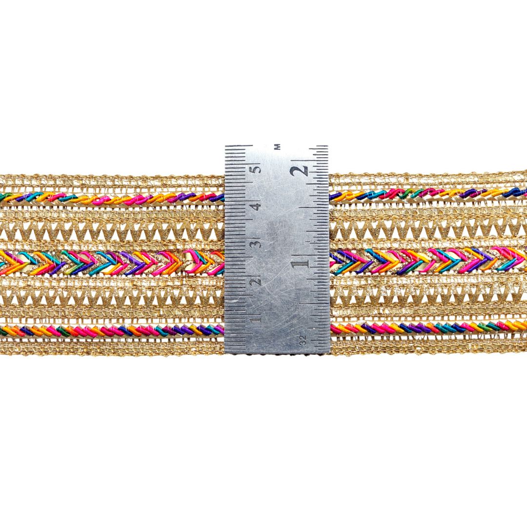 Multicolored braided trim with a ruler for scale on a white background