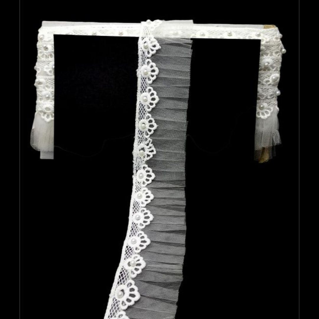 White lace headband with floral details on a black background