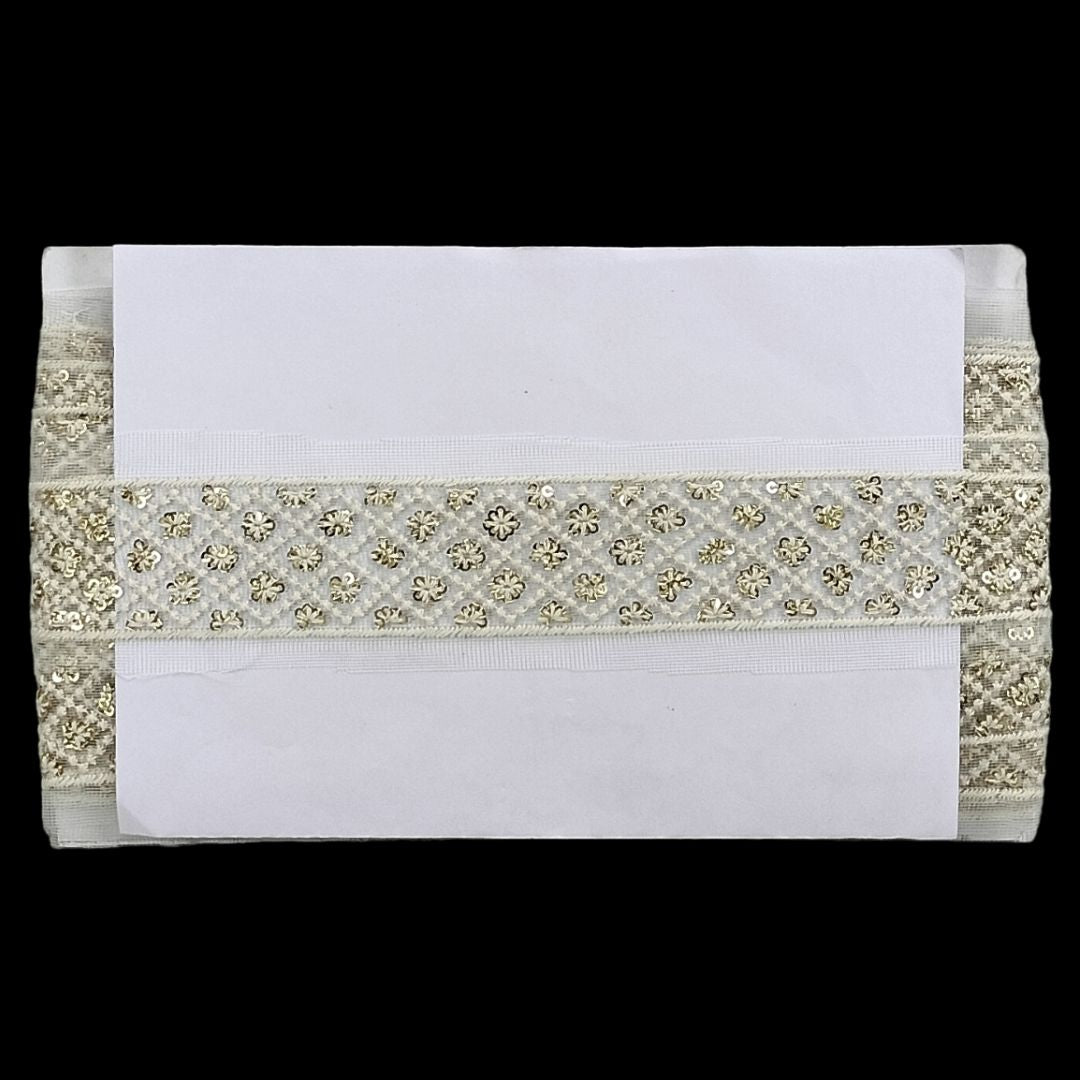 Decorative ribbon with gold embellishments on a white background