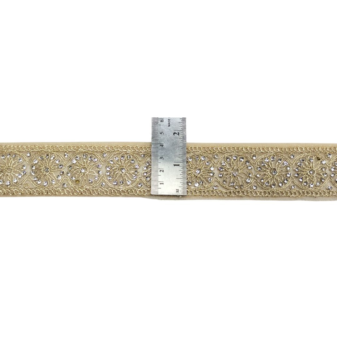 Decorative ribbon with intricate patterns and a ruler for scale on a white background