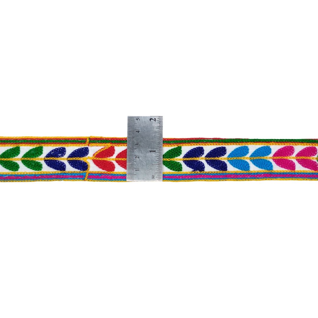 Colorful woven belt with a ruler for scale on a white background
