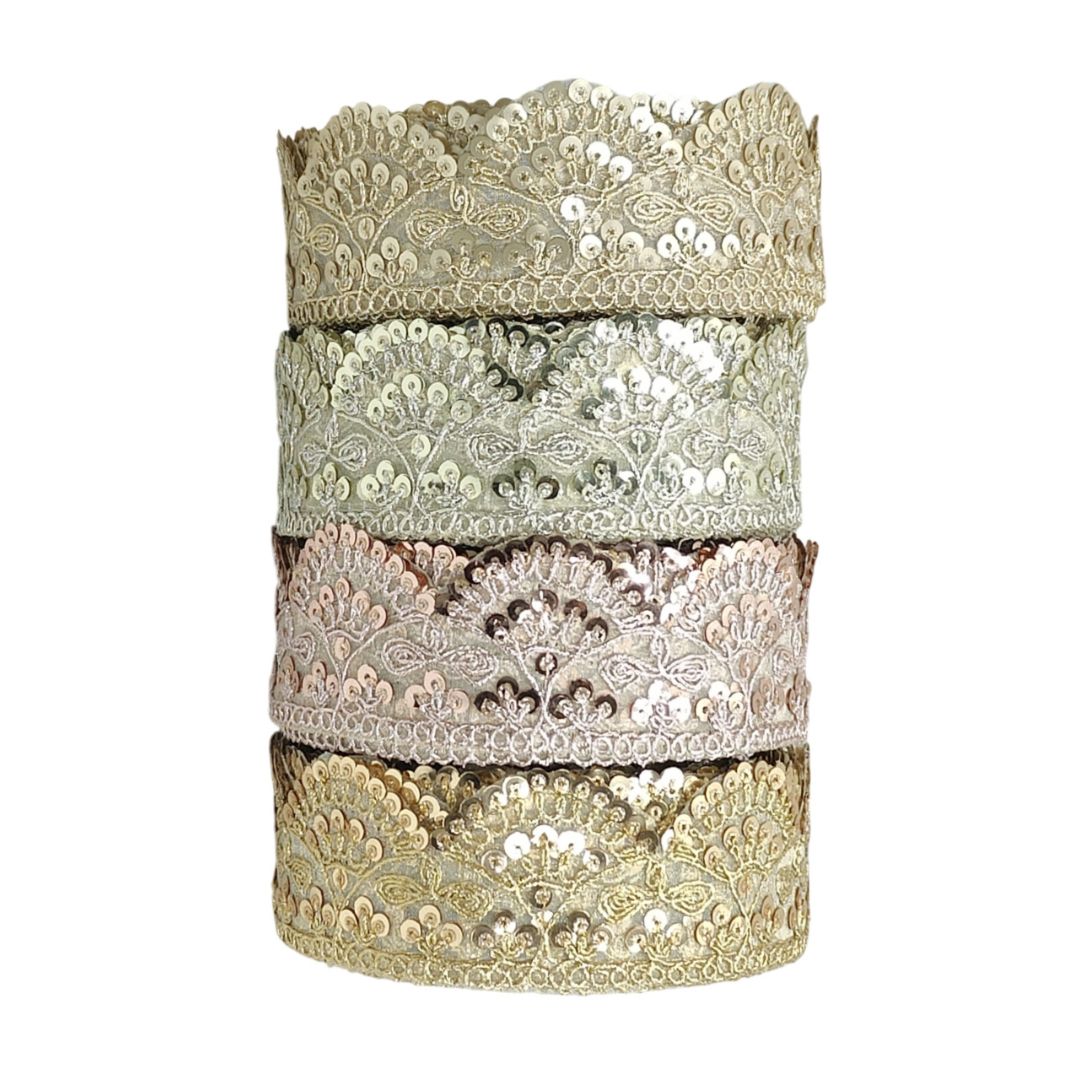 Set of four decorative lace ribbons in gold, silver, and bronze on a white background