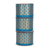 Three rolls of blue ribbon with gold patterns stacked on a white background