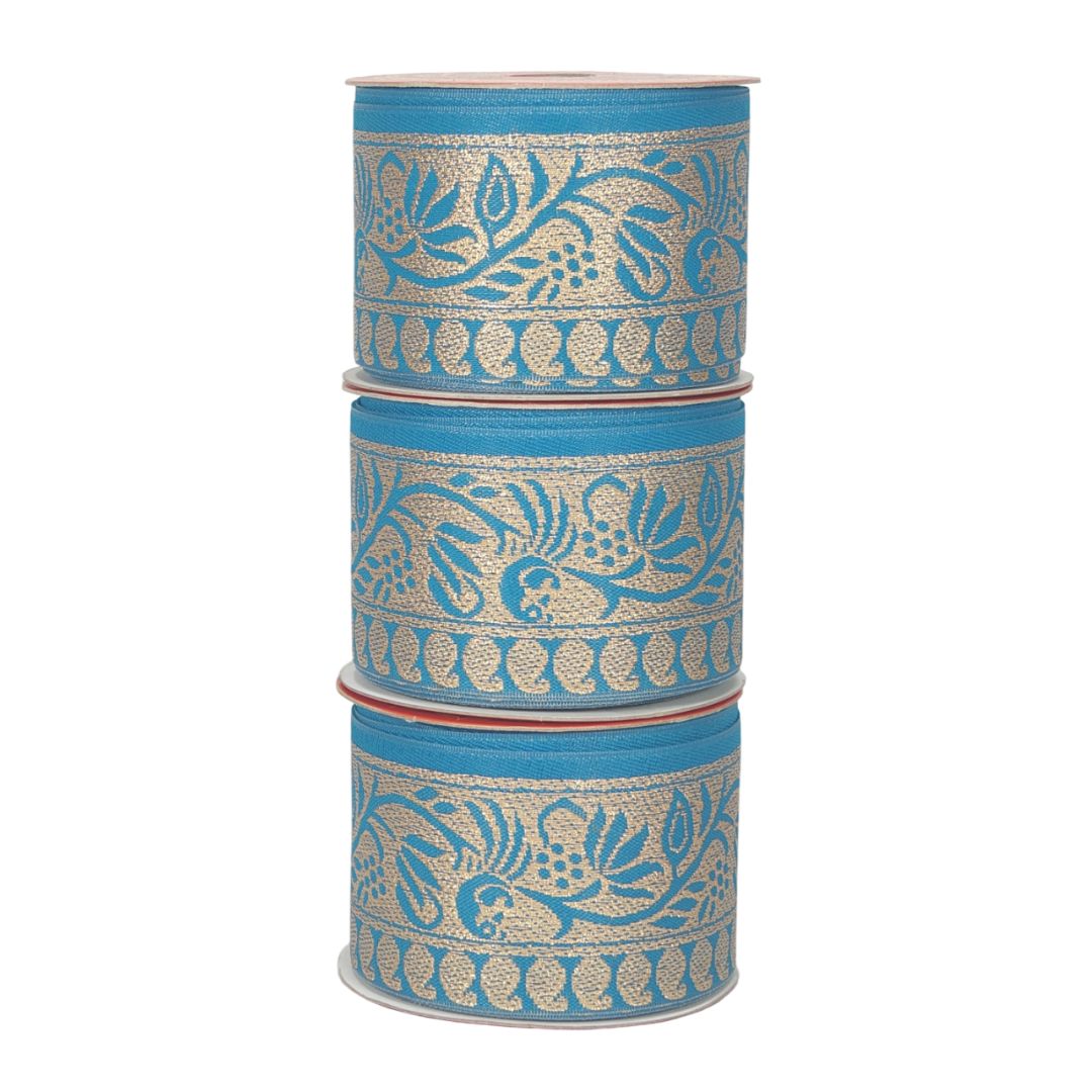 Three rolls of blue ribbon with gold floral patterns on a white background