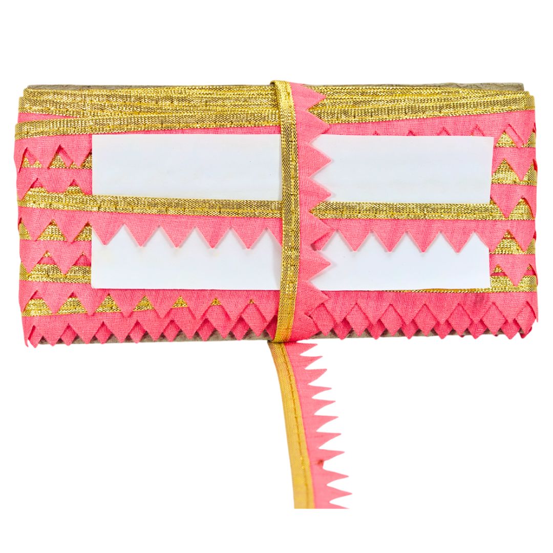 Pink and gold traditional fabric with white patterns on a white background