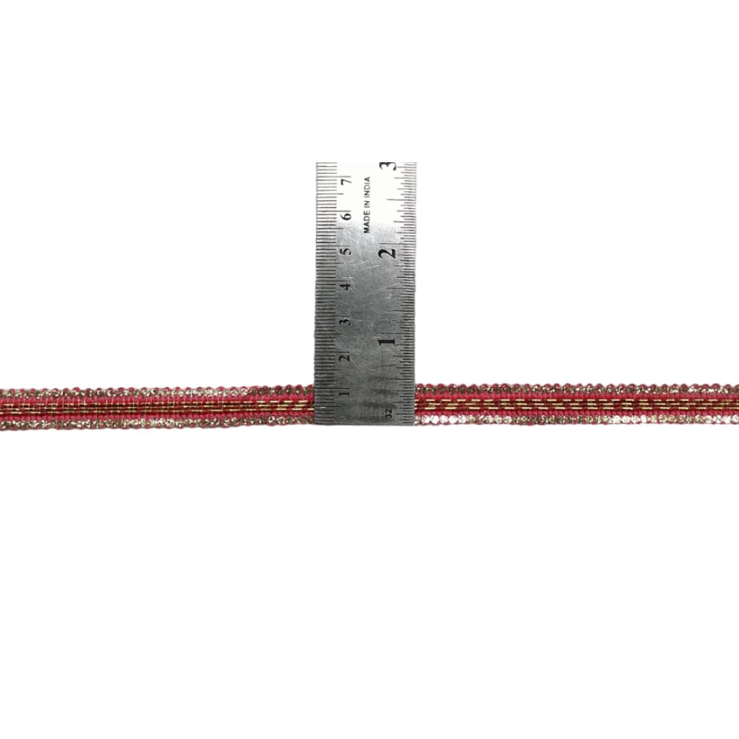 Red and silver beaded cord with a ruler for scale on a white background