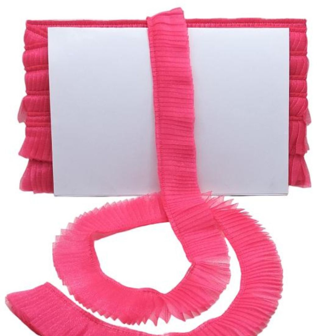 Pink ribbons with a white card on a white background