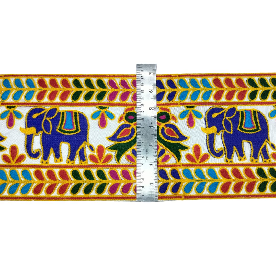 Decorative border with elephants and colorful patterns, measured by a ruler.