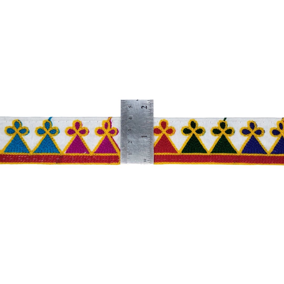 Decorative ribbon with colorful patterns and a ruler for scale on a white background
