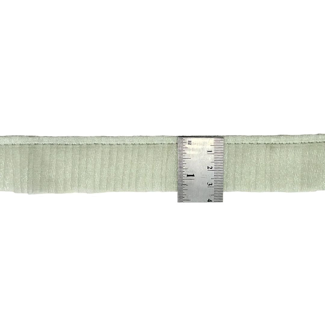 Green woven belt with a ruler for scale on a white background