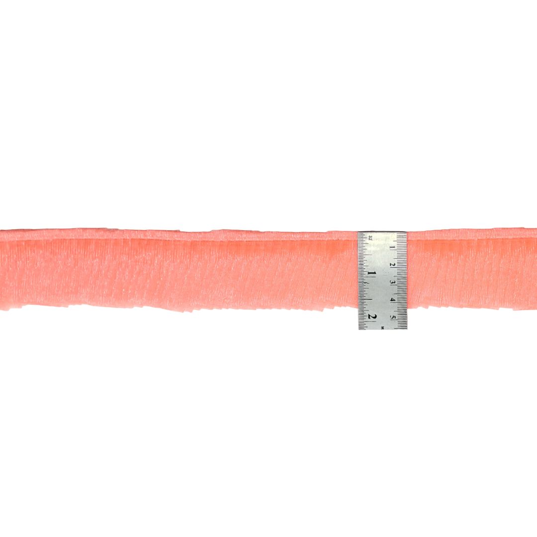 Peach-colored ribbon with a ruler for scale on a white background