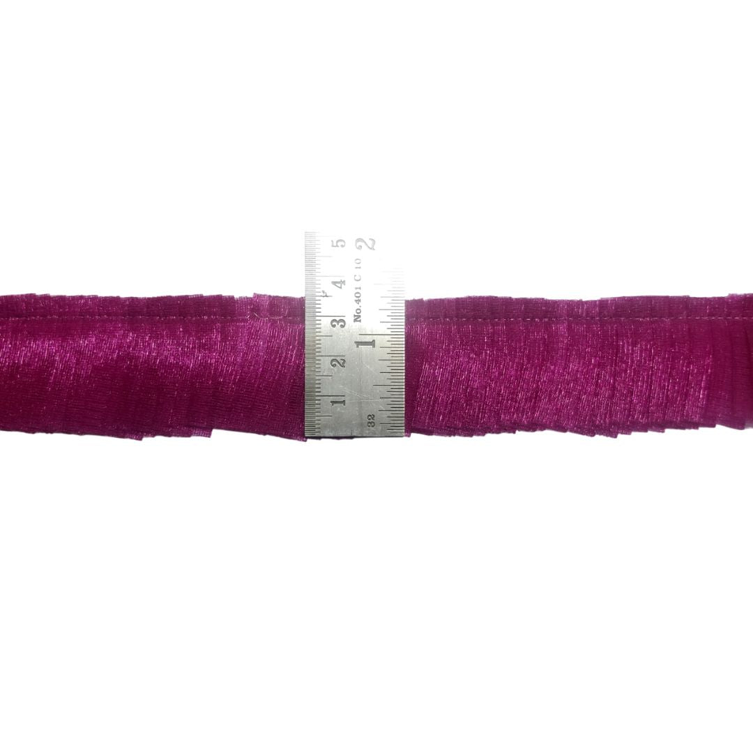 Purple fabric with a ruler for scale on a white background