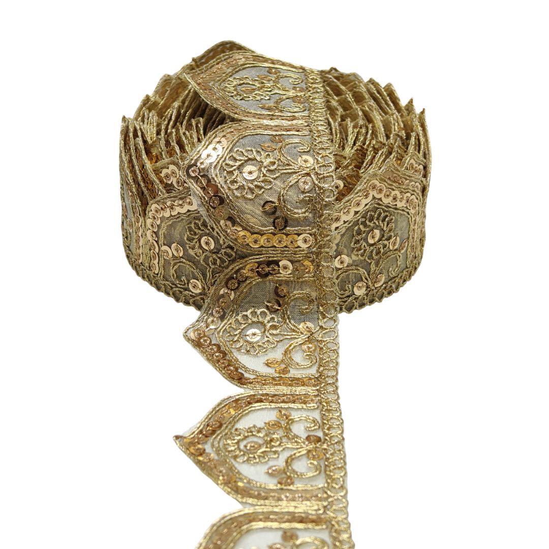 Decorative gold ribbon with intricate patterns on a white background