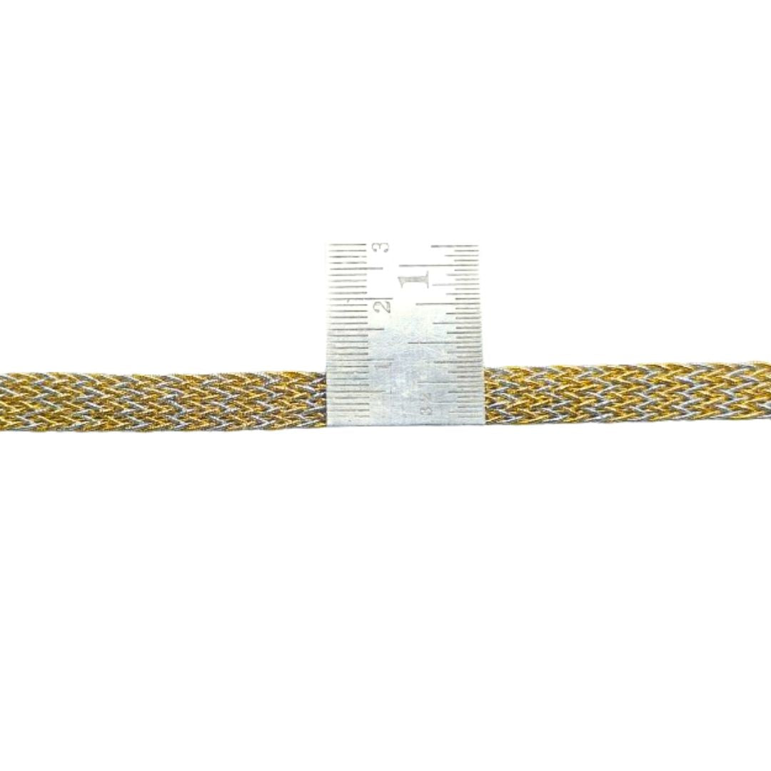 Gold and gray braided cable with a ruler for scale on a white background