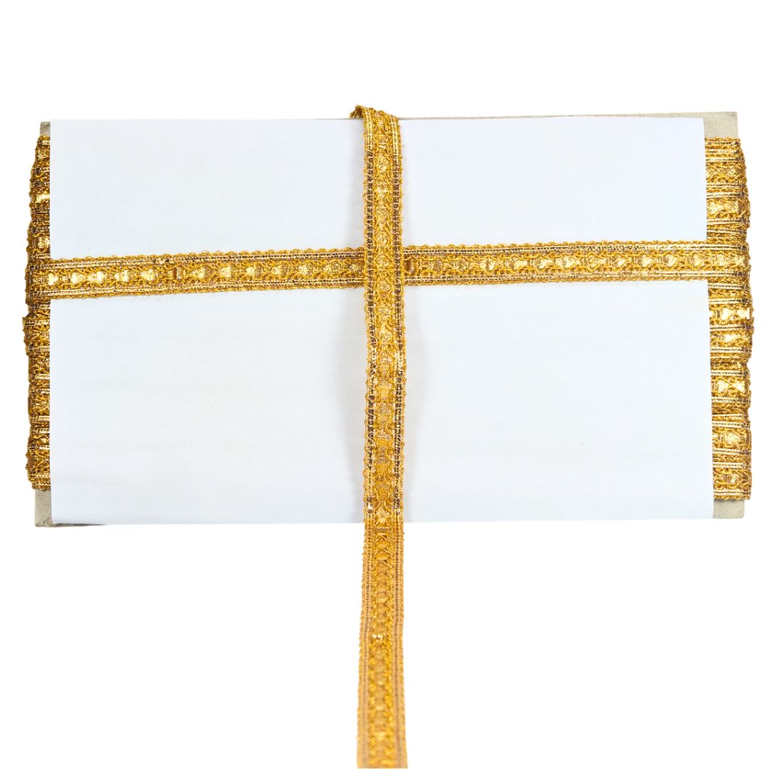White clutch with gold decorative strap on a white background