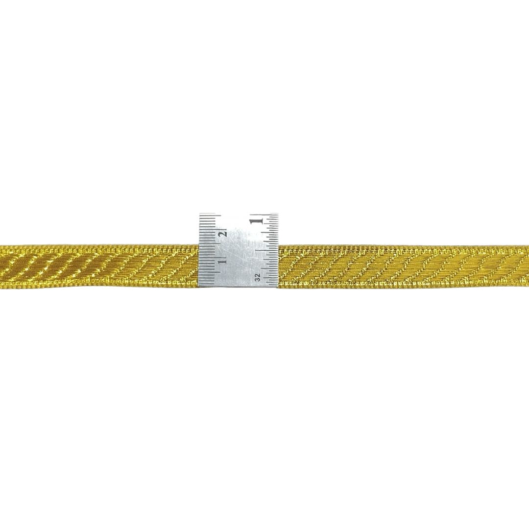 Gold braided cord with a ruler for scale on a white background