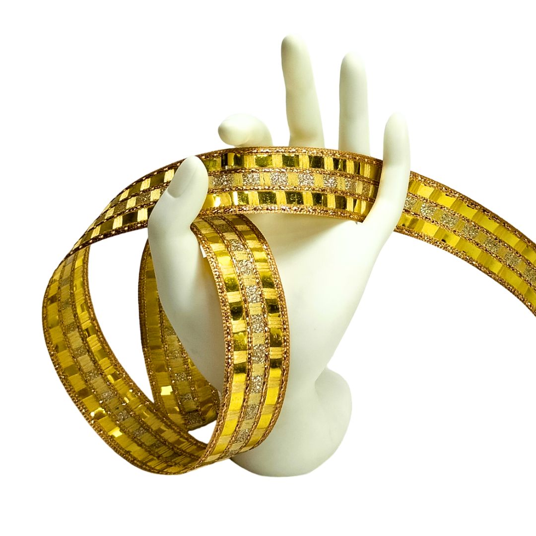 Gold bangles with diamond-like stones on a white mannequin hand