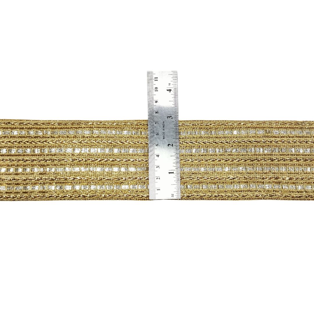 Gold thread with a ruler for measurement on a white background