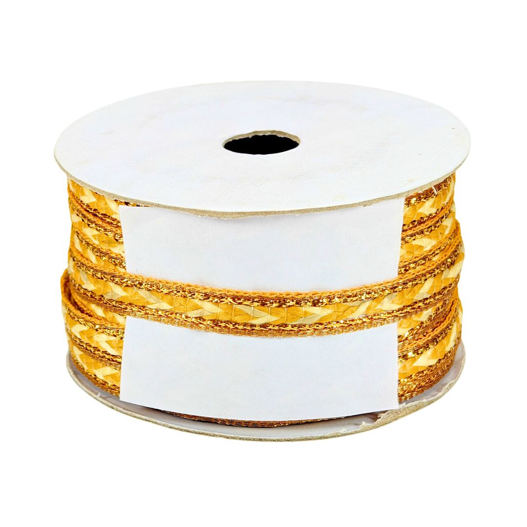 Spool of gold ribbon with a white label on a white background