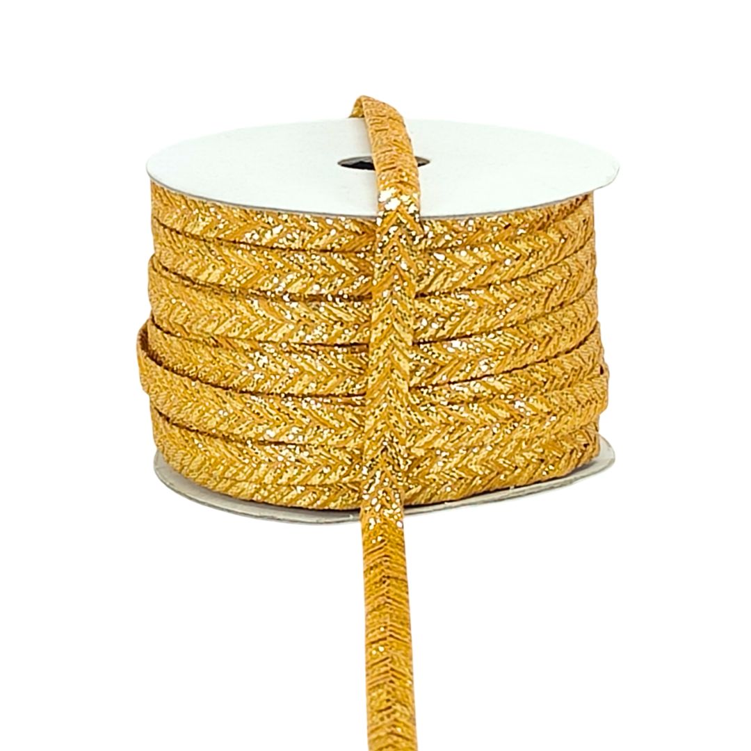 Spool of gold glitter ribbon on a white background