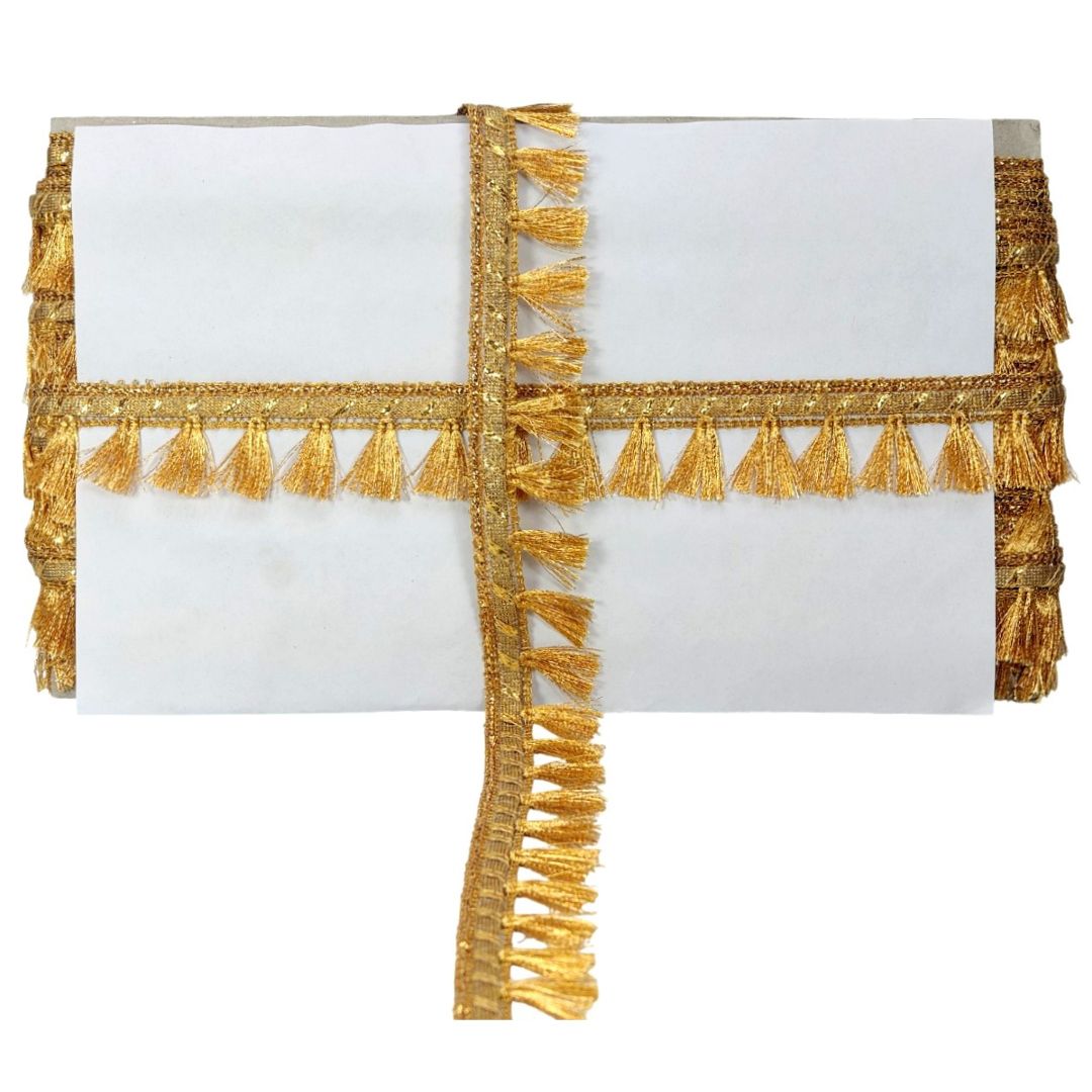 White clutch with gold tassel detailing on a white background