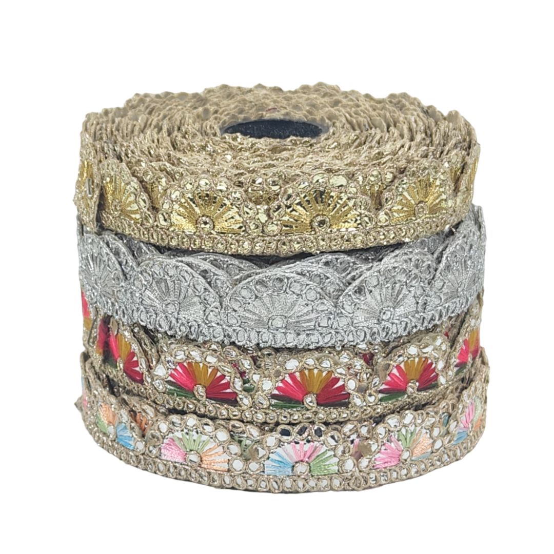 Stack of decorative ribbons with gold, silver, and multicolored patterns on a white background